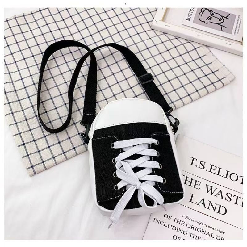 Black trainer shape canvas crossbody bag with white laces