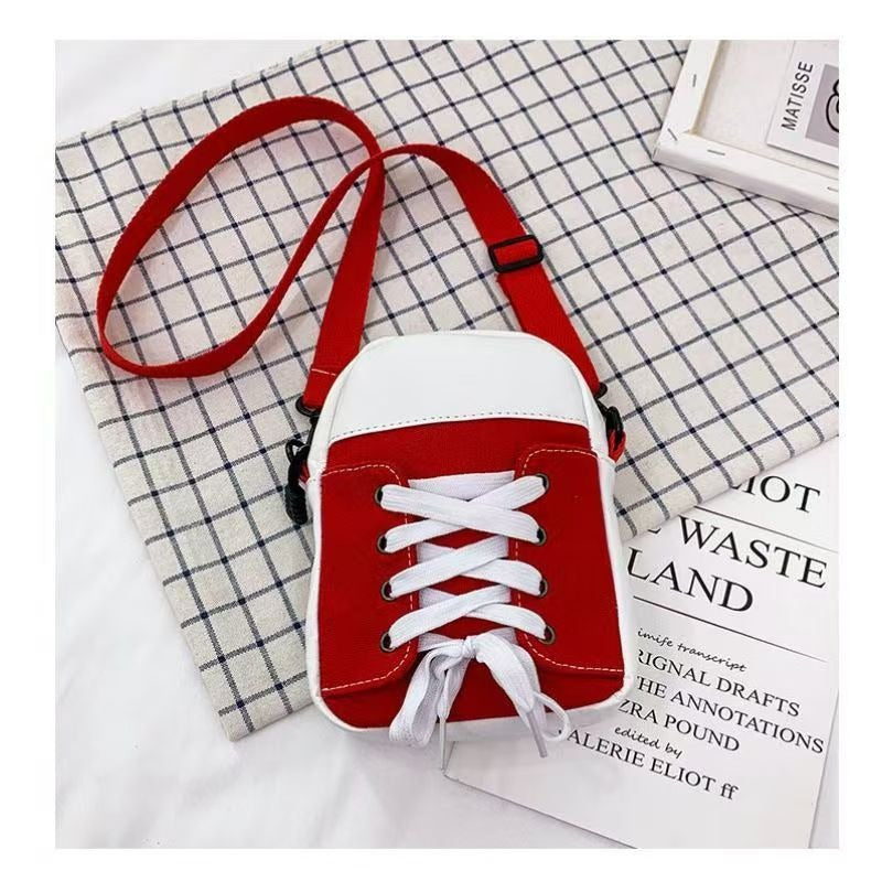 Red trainer shape canvas crossbody bag with white laces