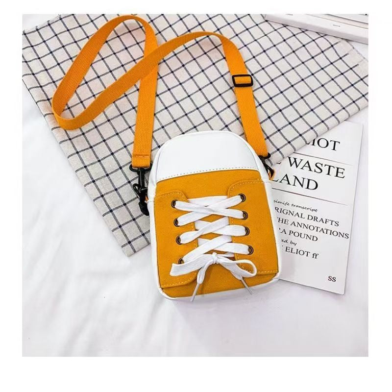 Yellow trainer shape canvas crossbody bag with white laces