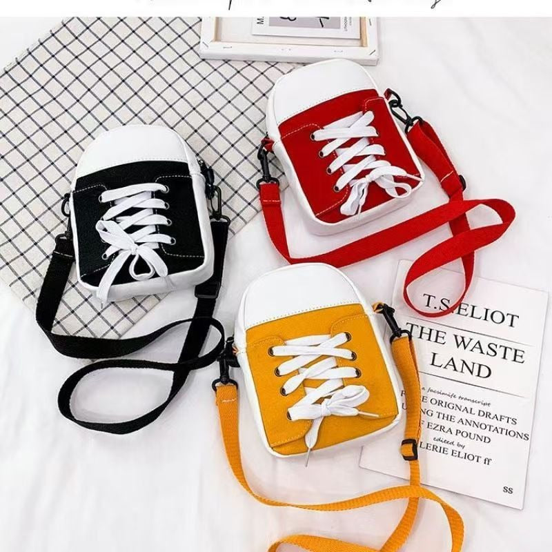 Trainer shape canvas crossbody bags in black, red and yellow