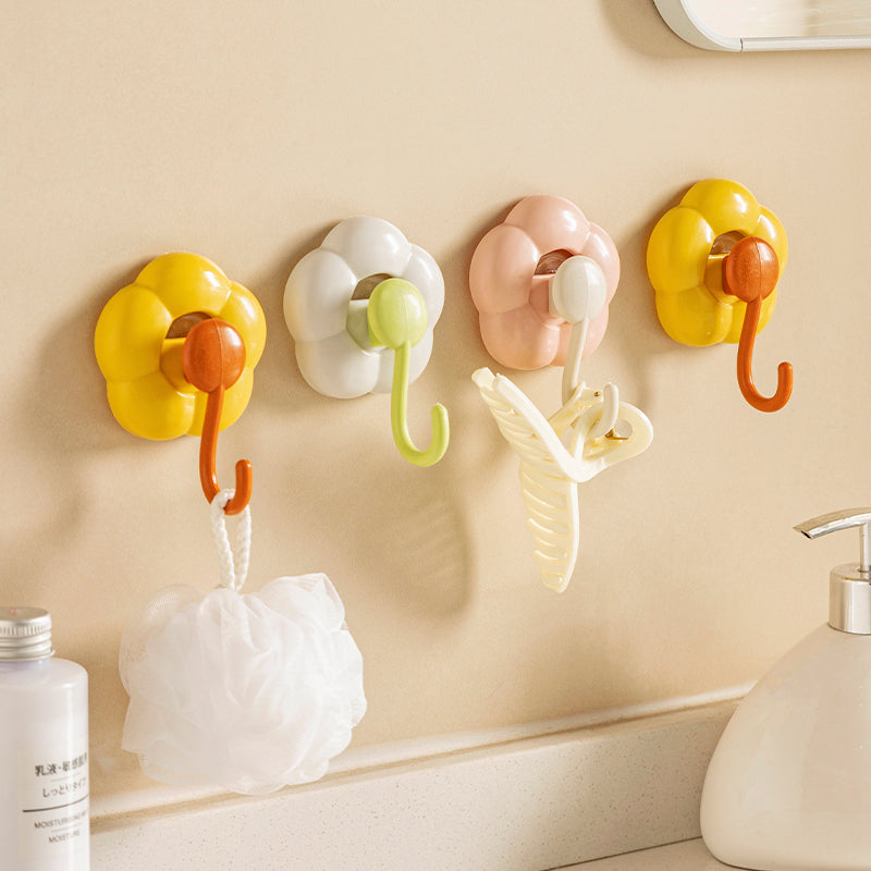 Colorful flower-shaped wall hooks in a bathroom holding bath accessories