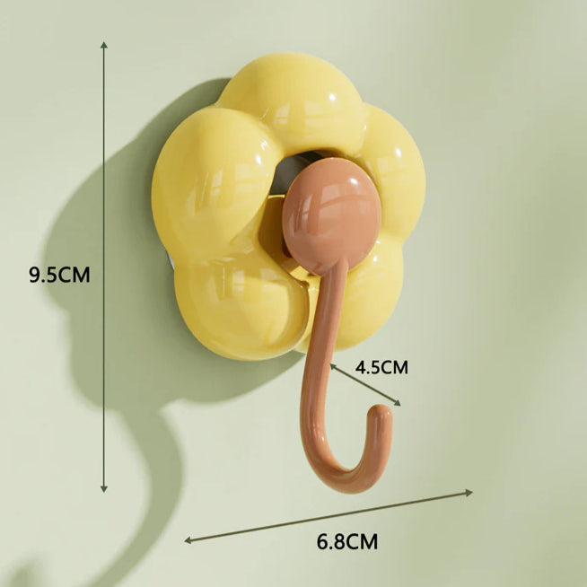 Yellow flower-shaped wall hook with brown hook and size measurements for home organization