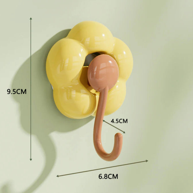 Yellow flower-shaped wall hook with pink hook, minimal modern design, size measurements shown.