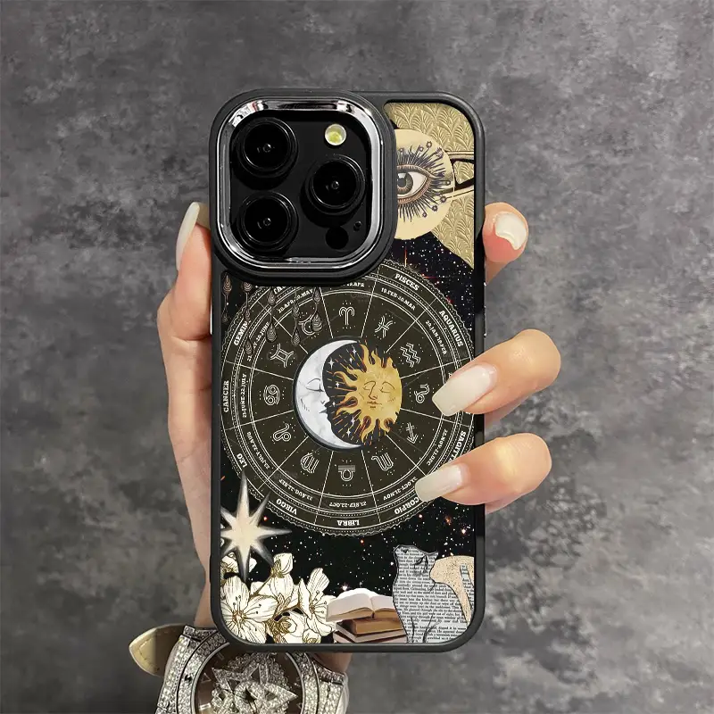 Hand holding phone with zodiac astrology case, sun and moon design, minimal style