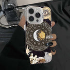 Astrology zodiac iPhone case with celestial sun moon design, black stiletto nails holding phone