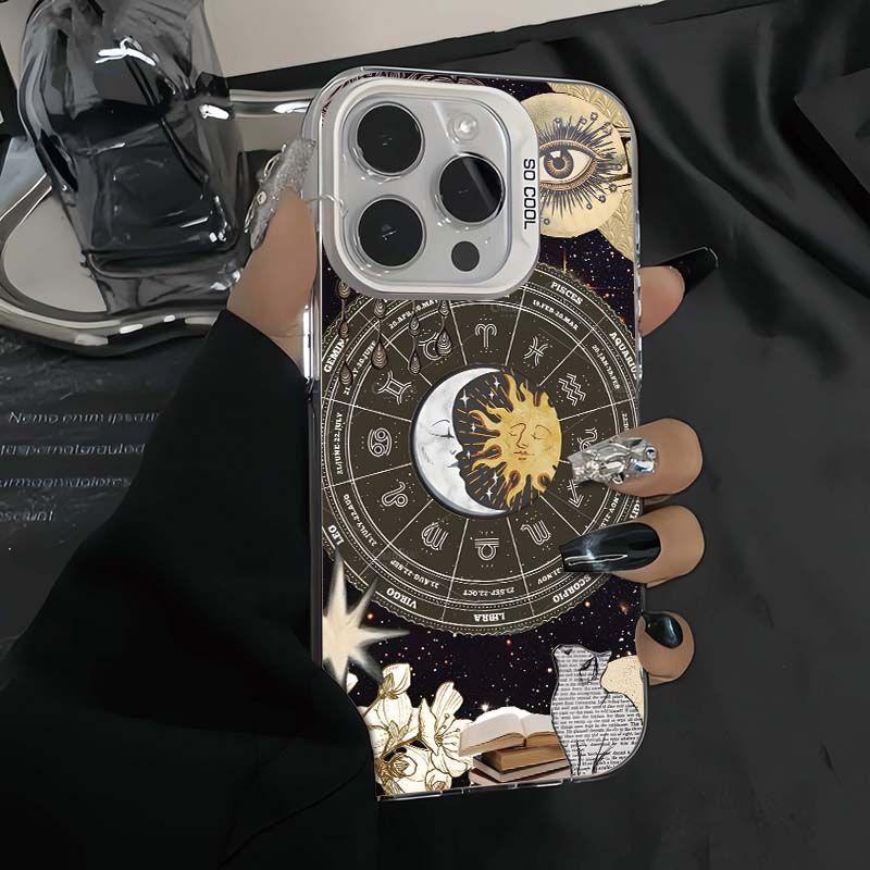 Astrology zodiac iPhone case with celestial sun moon design, black stiletto nails holding phone