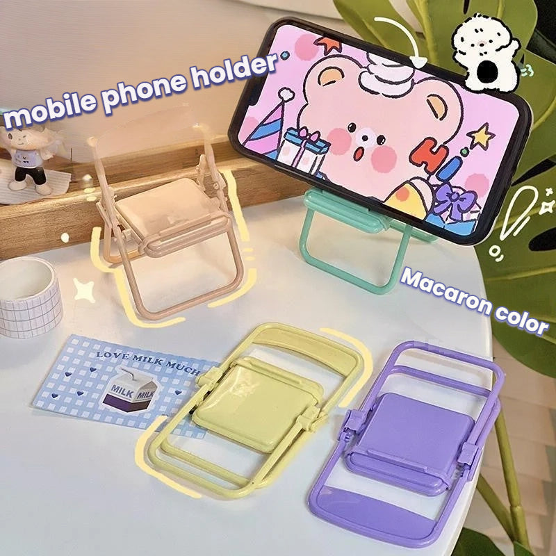 Foldable pastel mobile phone holders in macaron colors on desk, modern minimalist design