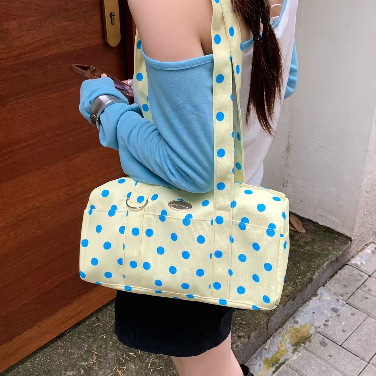 Butter Yellow Dot polka dot boston bag worn on the shoulder